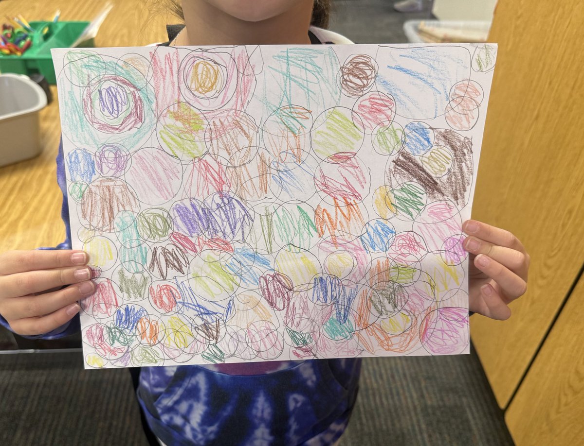 Hallway duty:
A 1st grader walked up to me, held out a carefully colored picture, and said,
“Do you remember when you taught us to use bottle caps to make a picture with only circles? I made this at home with a Gatorade lid, a magnifying glass, and a tape ring. It’s for you.” 🥰