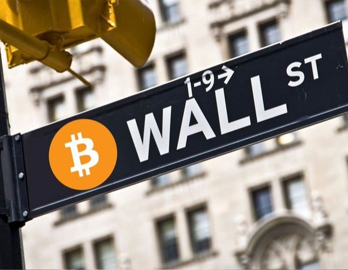 First image displays a yellow traffic light above a street sign reading 1-9 Wall St with an orange Bitcoin symbol integrated into a black Wall St signpost against a blurred urban building background. Second image shows the modern glass entrance of BNY Mellon headquarters with its blue and white logo above the doors flanked by potted evergreen trees and blurred pedestrians entering the building on a city sidewalk.