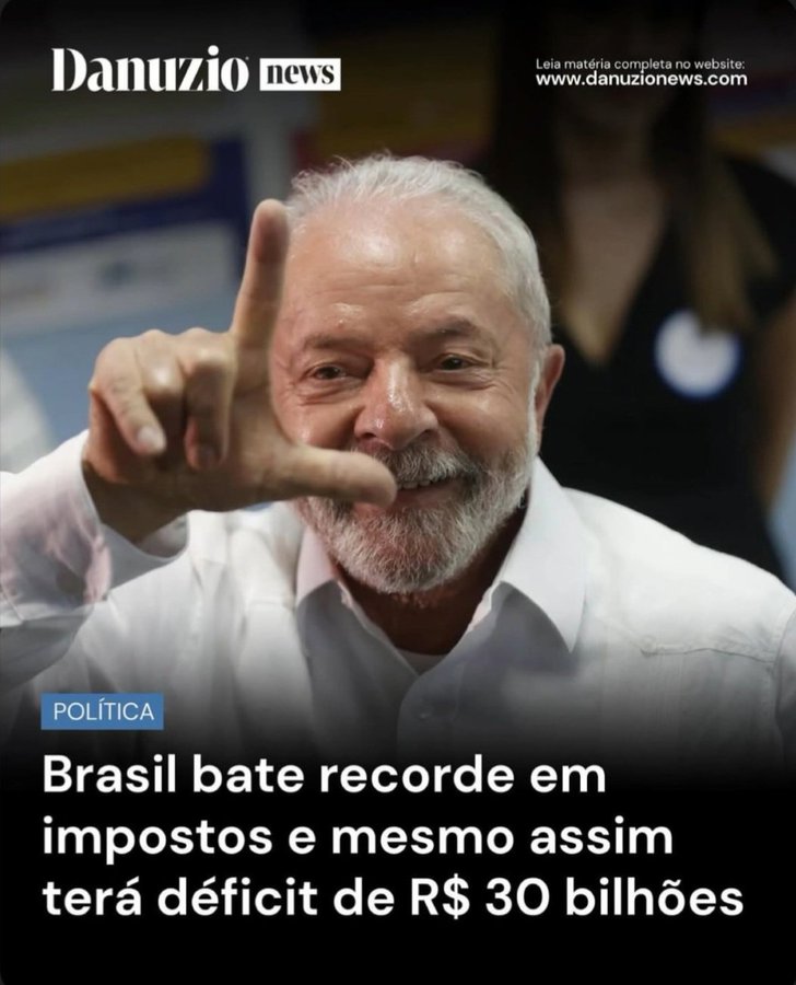 An older man with gray hair, mustache, and beard smiles while making a peace sign gesture with his right hand near his face, dressed in a white collared shirt against a blue background. The image has a Danuzio News logo and website in the top left, with Portuguese text overlay reading POLITICA Brasil bate recorde em impostos coletados e mesmo assim tera deficit de RS 30 bilhoes in white font on blue banner at bottom.