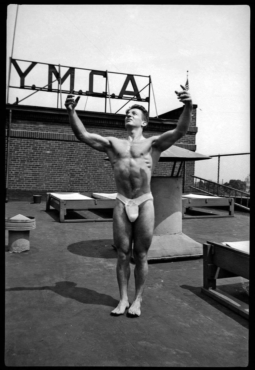 Photographer: Harold Feinstein (American street photographer). Model: Franco Columbo (bodybuilder who later became a two-time Mr. Olympia title holder). 1968.
Behind the athlete, you can see a sign that says “Y.M.C.A.,” which stands for Young Men's Christian Association, an