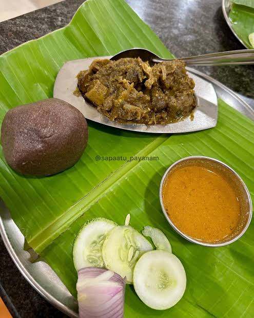 Traditional South Indian ragi mudde meal served on a banana leaf with curry and sides