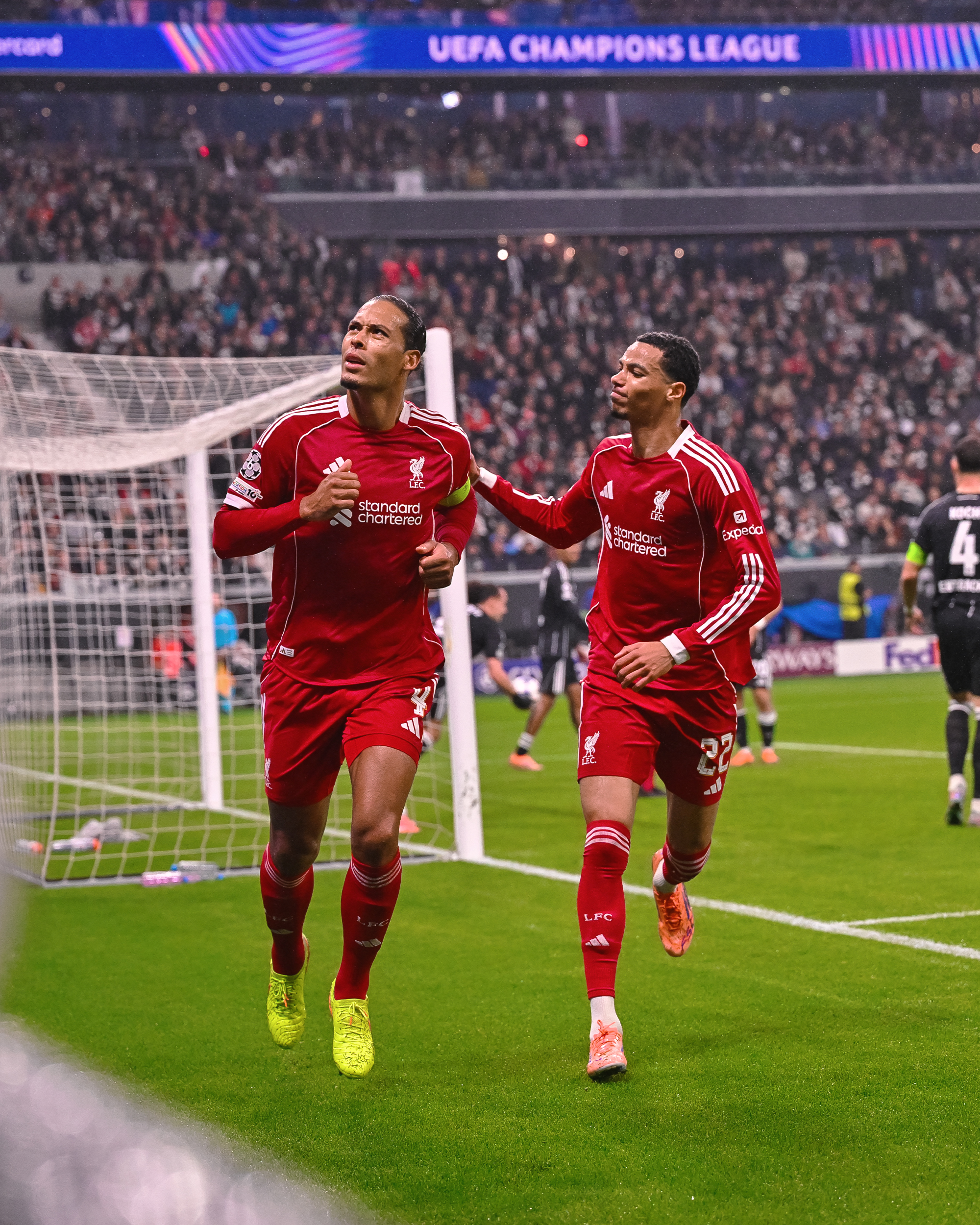 Photography of Virgil van Dijk and Hugo Ekitike celebrating after Van Dijk's goal against Frankfurt.