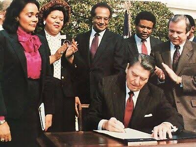 Is this AI generated? A white conservative signed the bill to make MLK a national holiday? That can’t be right.