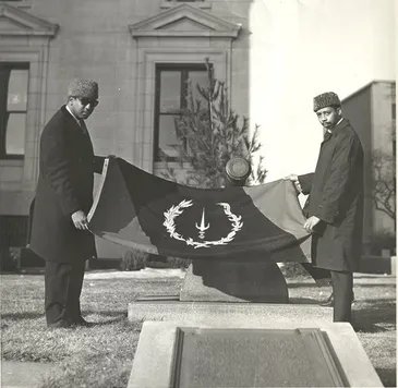 Melvin Charles and Gleason Jackson holding the Black American Heritage Flag outside the Union County Courthouse, Elizabeth, New Jersey (1967).