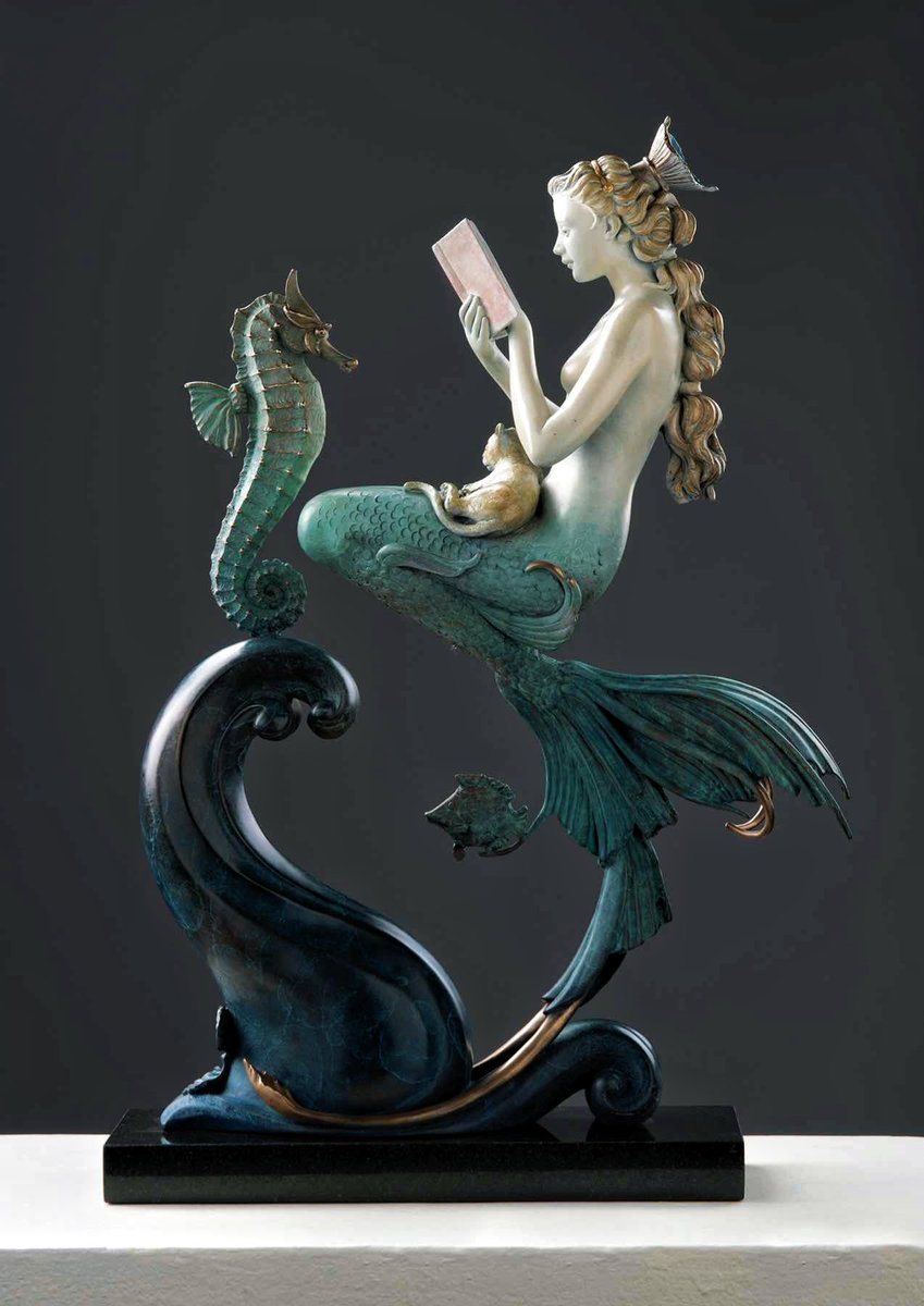 LeoDaVinciWave's tweet image. A beautiful moment of magical realism. This bronze sculpture, &quot;The Mermaid&apos;s Secret&quot; by Michael Parkes, captures a mermaid peacefully reading a book with her feline companion and a seahorse nearby.