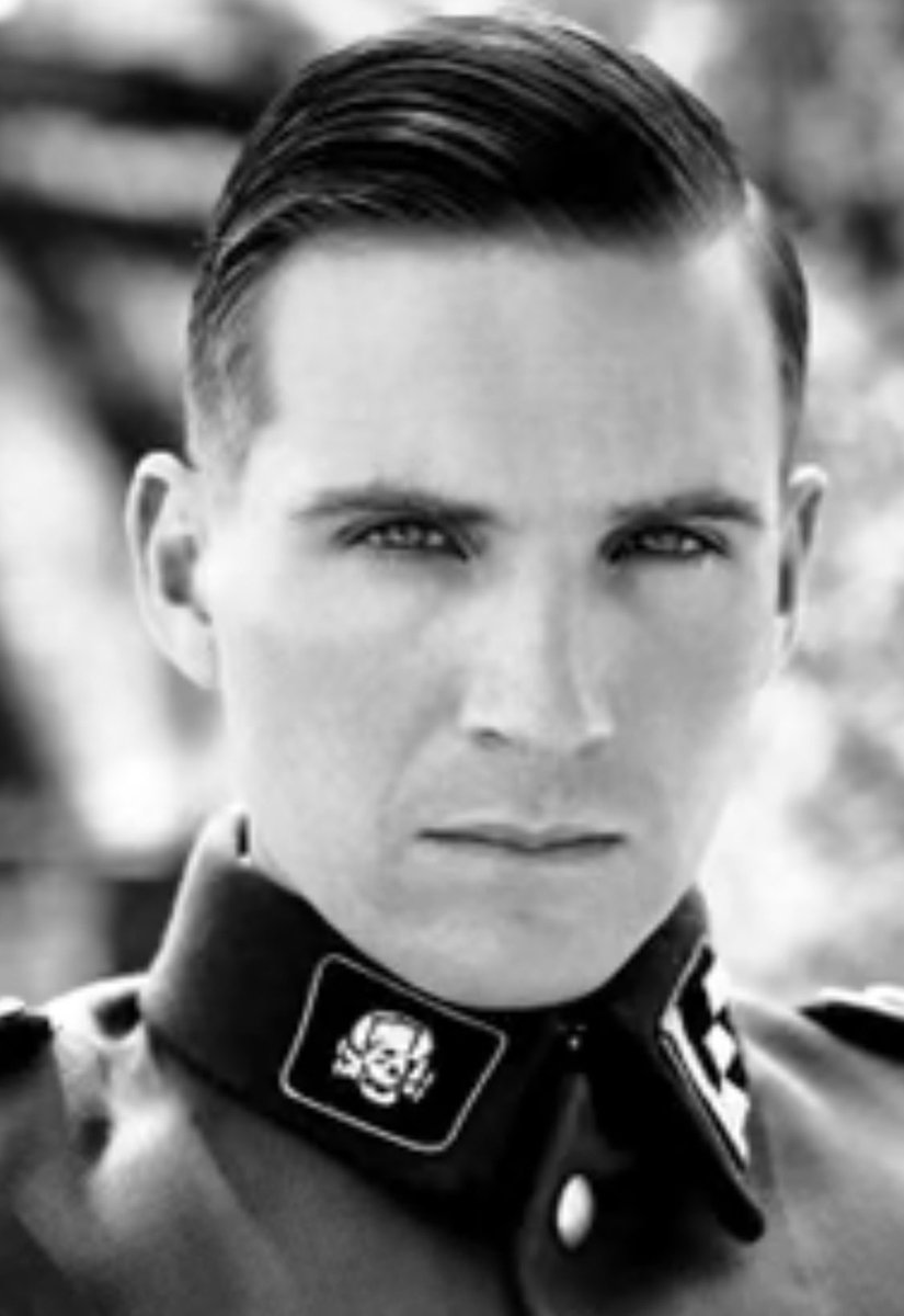I can't take credit for this but I really REALLY wish I could, somebody else pointed out that his tattoo is literally the emblem Ray Fiennes has on his collar in Schindler's list.