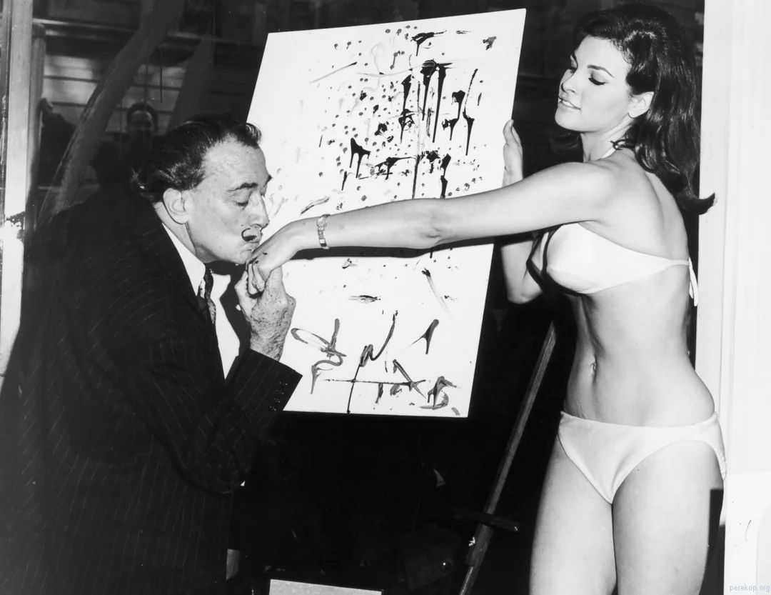 fasc1nate's tweet image. Salvador Dalí kisses 25-year-old Raquel Welch's hand in front of his abstract portrait of her, 1965.