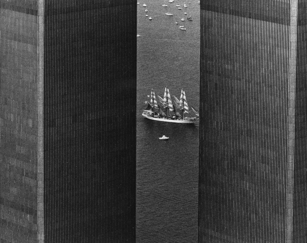 USS Constellation between the Twin Towers taken by Eddie Adams (1976)