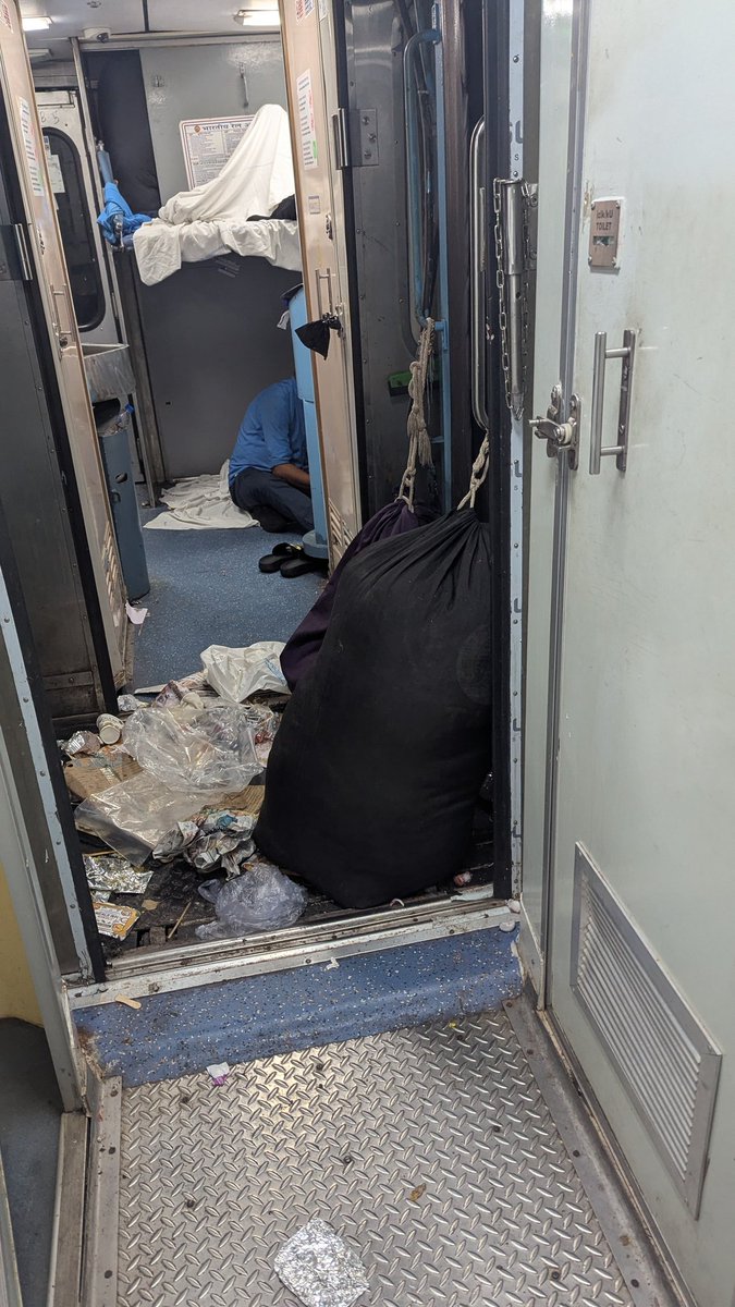 Patil4Akshay's tweet photo. Travelling in Rajadhani express From RC to KSR train number 22692. The coach is full of garbage near the washroom. They have kept some baggage there I think they are giving bedsheets or pillow covers from that. If that is the case it's concerning. Please have a look into it. https://t.co/GrjMU1I2ZT