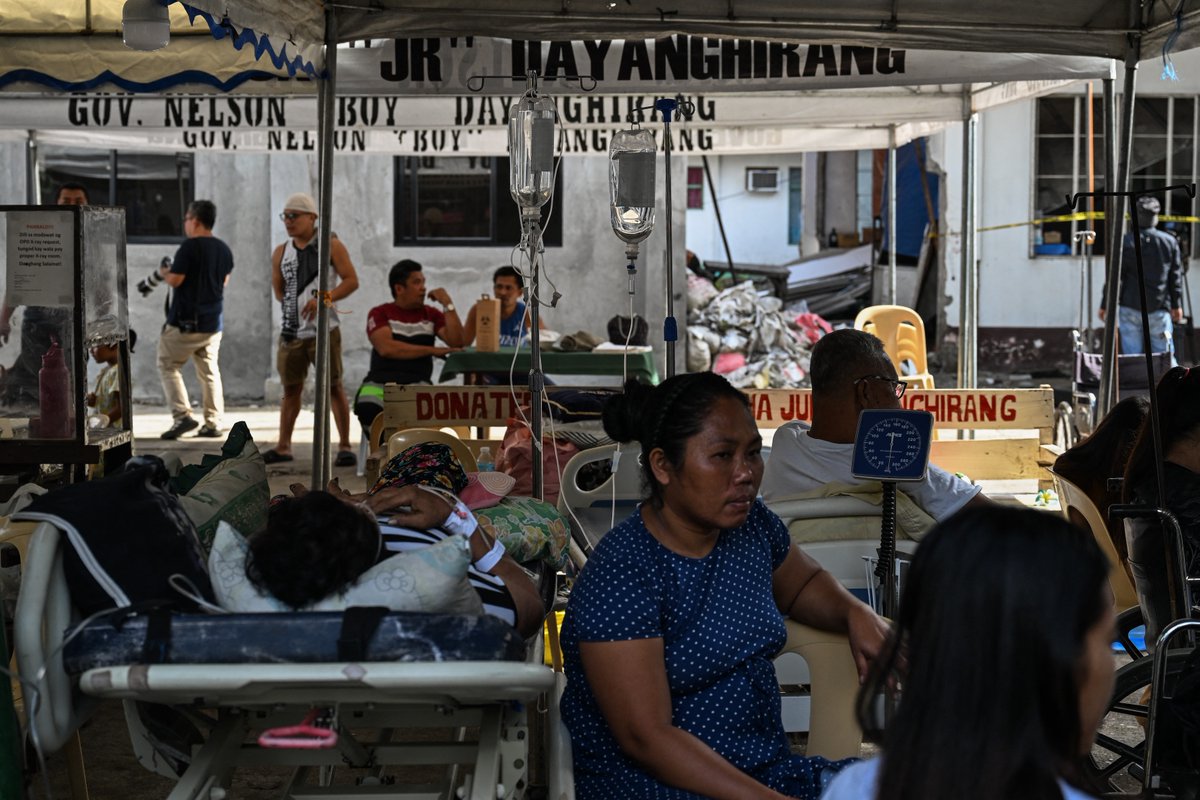 inquirerdotnet's tweet image. LOOK: Patients wait outside a damaged hospital in Manay, Davao Oriental, after two powerful earthquakes struck off the province on Friday, Oct. 10, killing at least eight people and triggering tsunami warnings that were later lifted. | 📷: Jam Sta. Rosa/AFP

•⁠ ⁠Follow live…