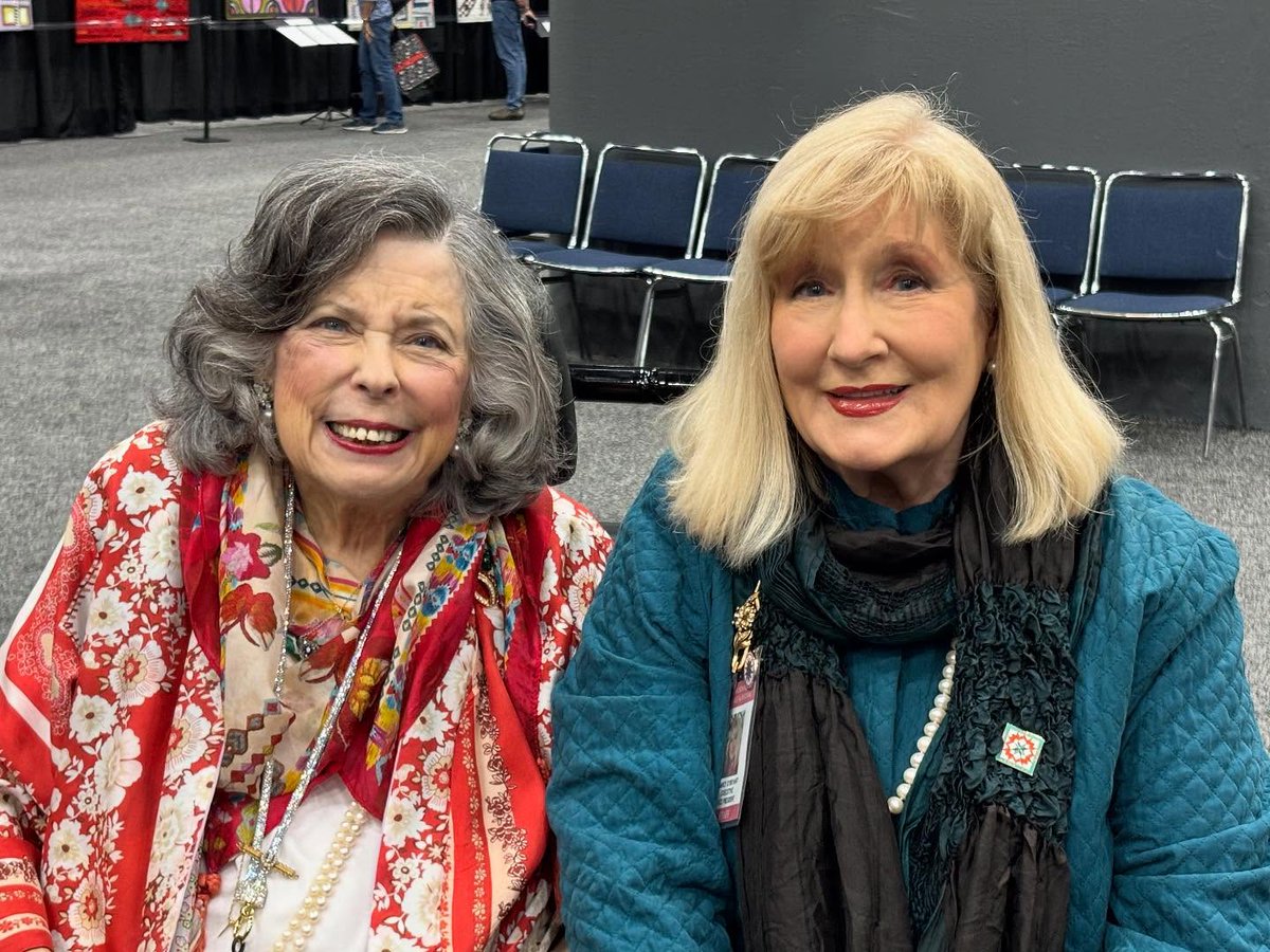 Quilt Festival Founder &amp; Director Emeritus Karey Bresenhan and Quilts, Inc. Exec. VP (and cousin!) Nancy O’Bryant enjoy the quilt display area.