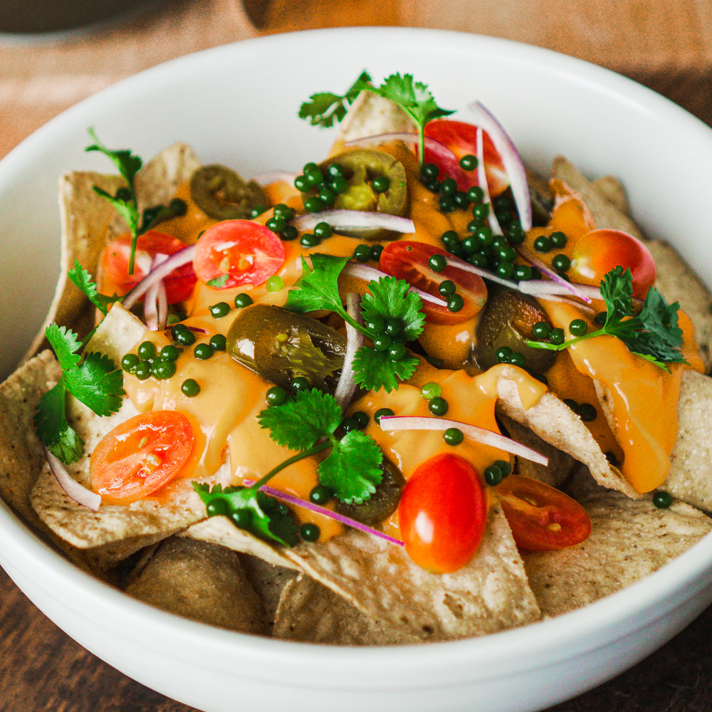 spherificator's tweet image. Cheesy nachos with a fresh twist. Cilantro pearls add a bold herbal kick to every crunchy bite 🧀🌿 #LoadedNachos #CilantroPearls #Spherificator #TheSpherificator #Spherification #MolecularGastronomy #NextLevelSnacks #FlavorPop #CreativeToppings #GameDayEats #FoodieFavorites