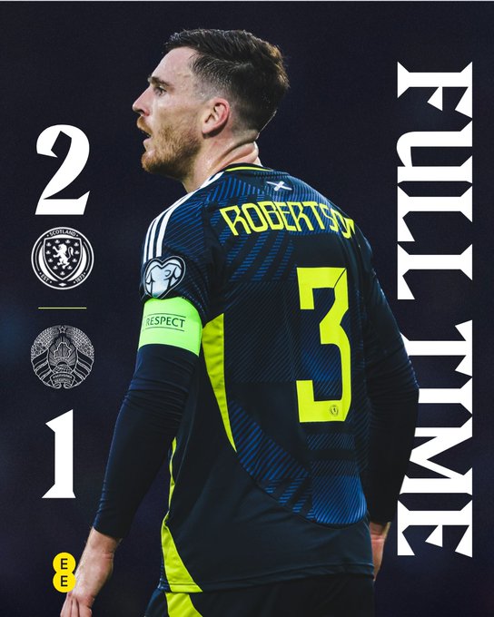 Graphic design displays full time score Scotland 2 Belarus 1 vertically on left side with team crest and sponsor logos. On right side shows rear view of player Lennon Miller wearing dark blue Scotland kit with number 3 on back yellow accents and sponsor patches standing in action pose. Background is dark with glowing effects around text and figure.