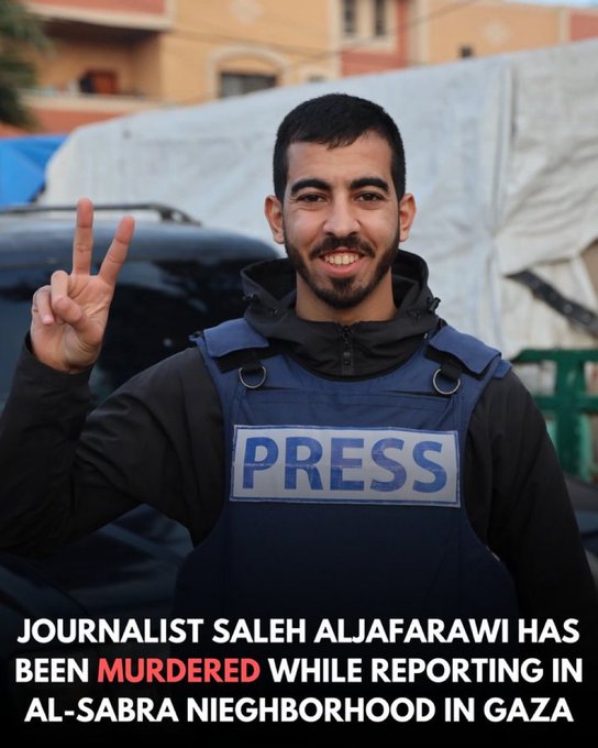 A man with short dark hair and a beard smiles while making a peace sign with his right hand raised near his face. He wears a black hoodie under a blue press vest labeled PRESS on the front. He stands outdoors near white tents, a black SUV, and beige buildings with Arabic text. Red overlaid text states Journalist Saleh Aljafaari has been MURDERED while reporting in Al-Sabra neighborhood in Gaza.