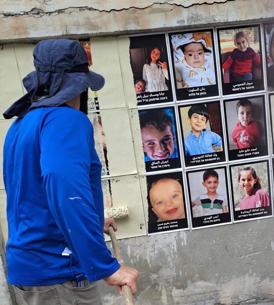 Tel Aviv-Jaffa municipality workers have shamelessly covered posters of Palestinian children killed in Gaza by the Israeli army.

They can cover their names and faces, but not the crime of killing them.