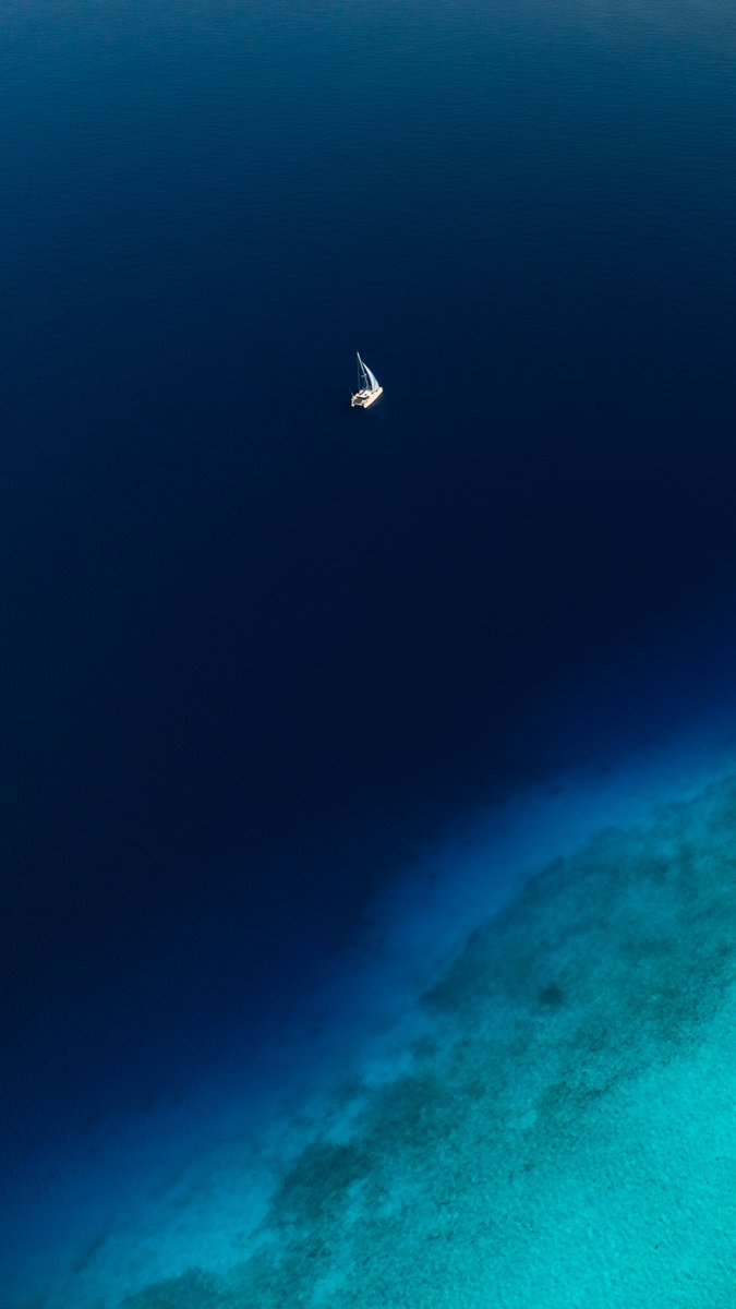 I am obsessed with this image. It captures what it feels like to head out into the deep blue nothingness better than anything else in my ocean collection.

My little family is on that boat, just going about their daily lives. It reminds you how small and vulnerable you are out