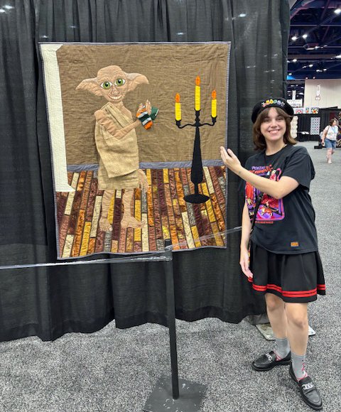 Big time "Harry Potter" fan Emma Ruggiero of Cypress, Texas meets Dobby the Elf in "Freedom" by Karen King-Giles in the exhibit "Reading and Remembrance: A Tribute to Barbara Bush." She was impressed with the inclusion of read socks!