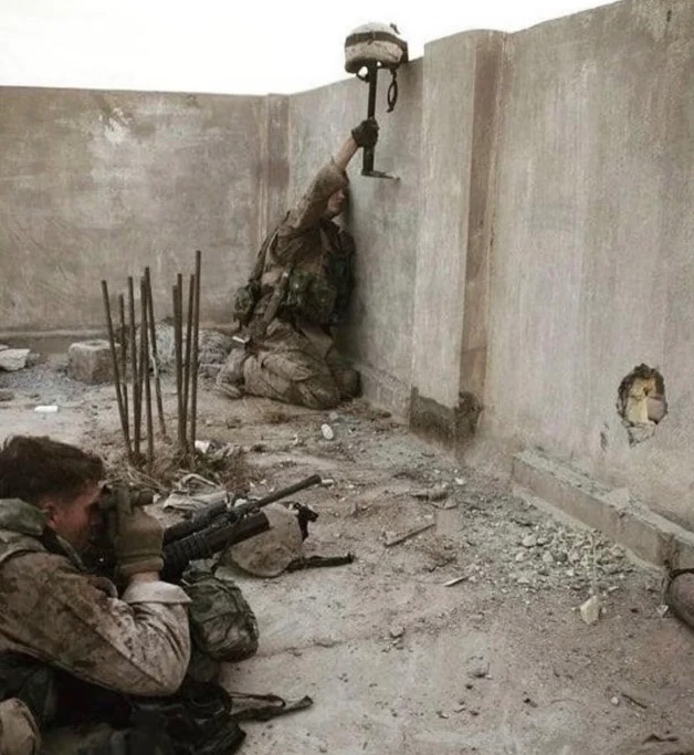 American Marine using his helmet as a decoy to locate an Iraqi sniper, 2003