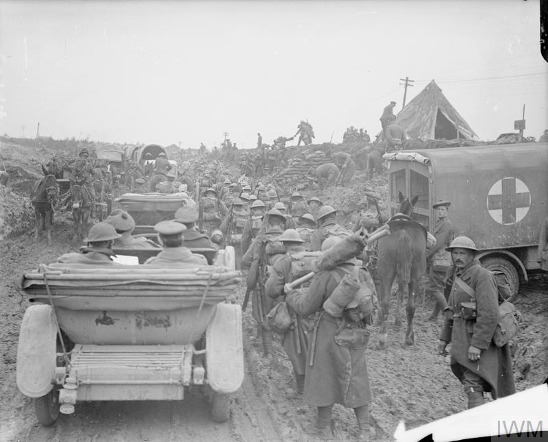 A congested road at Fricourt. Staff-cars, mule-limbers, lorries, RAMC ambulance, infantry marching and pioneers road widening. 13 October 1916.© IWM Q 5794
