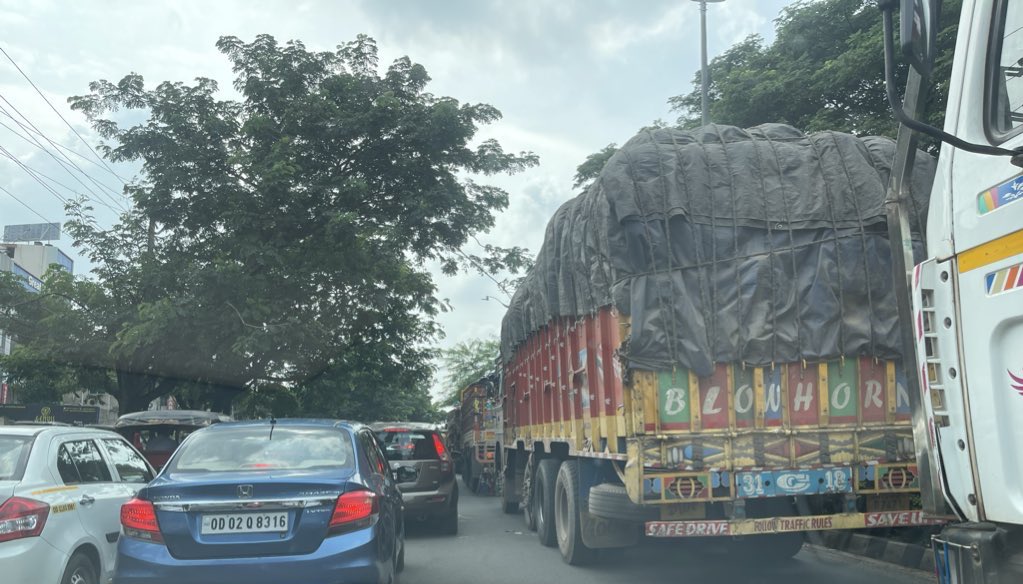 Multiple trucks are blocking the busy NandanKanan-Jaydev Vihar road near Kalarahanga Chhak, just before KIIT Square.

Trucks are prohibited on this route during this time. How did they all make it this far? Around 8-10 trucks.

<a href="/DCP_TRAFFIC/">DCP TRAFFIC, BHUBANESWAR-CUTTACK</a> <a href="/cpbbsrctc/">COMMISSIONERATE POLICE</a> <a href="/dcpbbsr/">DCP Bhubaneswar</a>