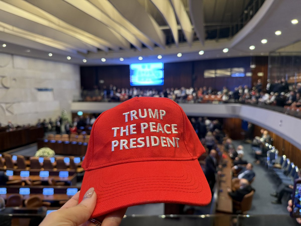 Special MAGA-style hats being handed around and worn by audience members in the Knesset
