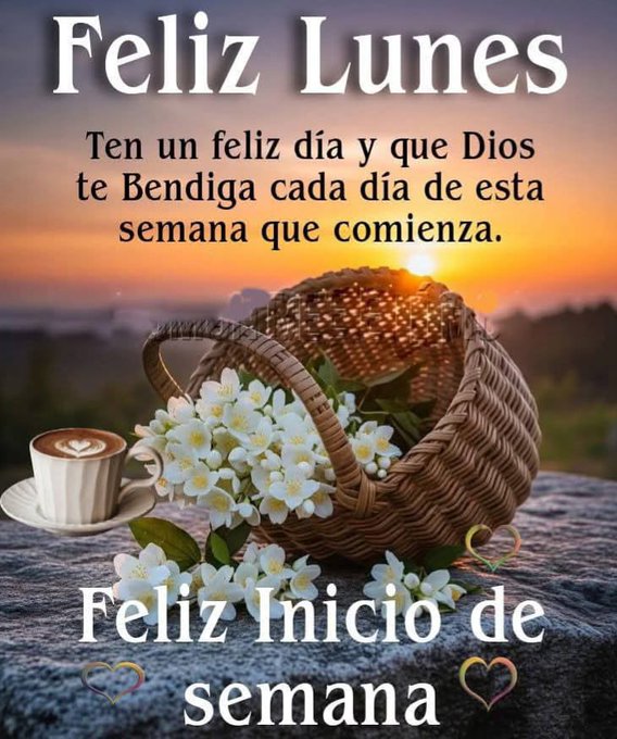 A woven basket filled with white flowers sits on a rocky surface against a sunset landscape with distant hills. Next to the basket is a white saucer holding a cup of coffee with foam. Overlaid text reads Feliz Lunes at the top, Ten un feliz dia y que Dios te bendiga cada dia de esta semana que comienza in the middle, and Feliz Inicio de semana at the bottom with heart symbols.