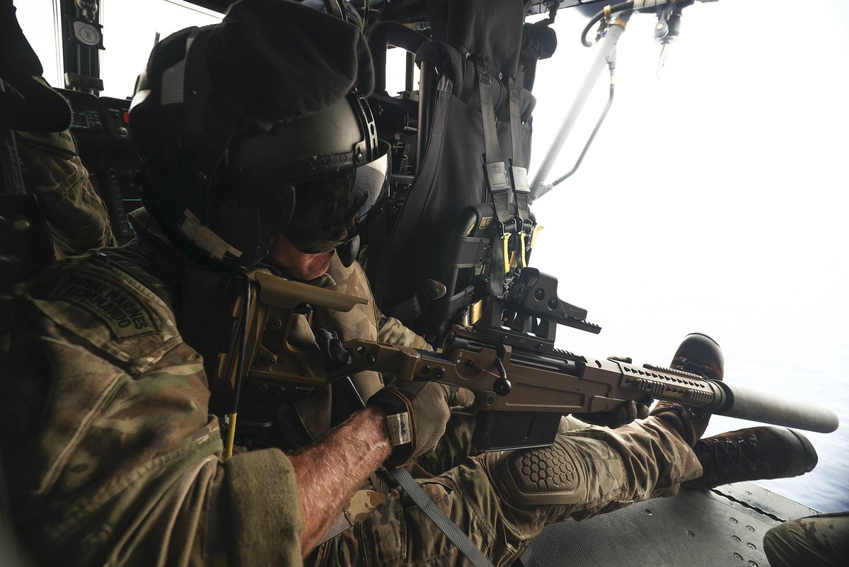 A Royal Marine with the Accuracy International AX50 .50 BMG rifle has recently disabled a fast moving drug boat off the Gulf of Oman. He fired a single round into the engine from a Wildcat helicopter flying backwards. Pretty neat!