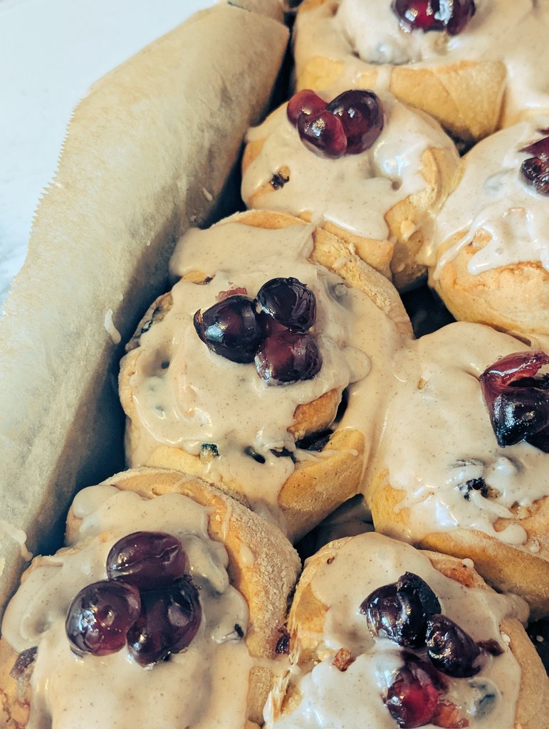 I'm at a loose end with no work, so I decided to use the time wisely and made Stollen Rolls.

Like Cinnamon Rolls, but filled with mixed spice, dried fruit, and marzipan, topped with spiced icing and cherries. 

They taste better than they look 🤤
