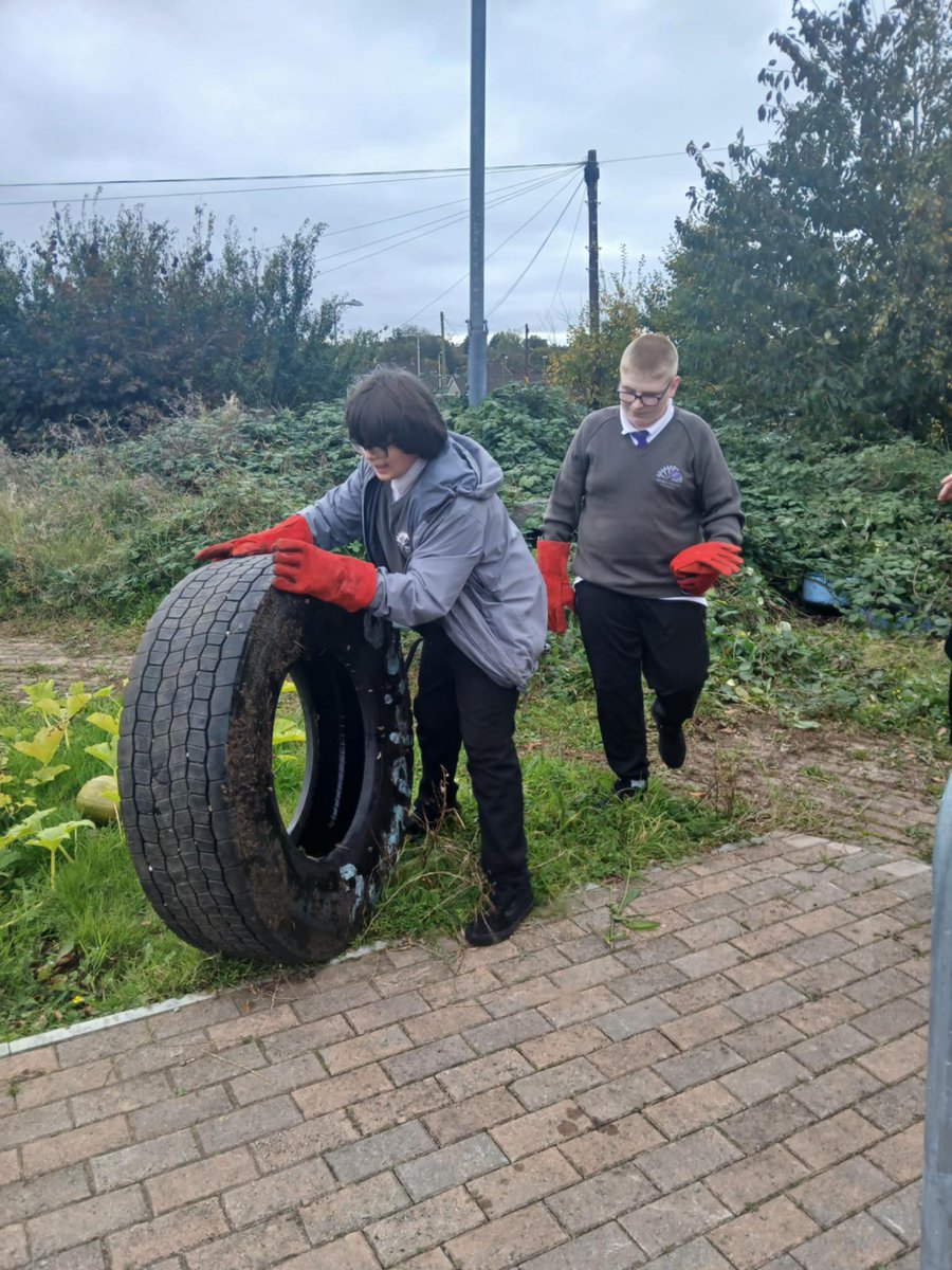 Some 11MLD learners making a start on the tidy up of the garden with Mrs Hudd.