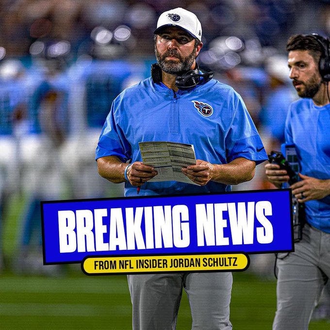 A man identified as Brian Callahan stands on a football field sideline wearing a white Titans cap, blue Titans polo shirt, gray pants, and headset, holding a stack of papers in his right hand while gesturing with his left, surrounded by other staff in similar blue uniforms and headsets, with a blurred stadium crowd in the background, and overlaid bold blue text banner at the bottom reading BREAKING NEWS FROM NFL INSIDER JORDAN SCHULTZ.