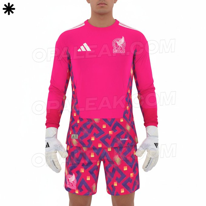 A male model stands in a plain studio wearing a pink long-sleeve goalkeeper jersey with white accents and a geometric pattern on the chest, featuring the Mexico national team eagle emblem on the left side and Adidas logo on the right. The jersey has OPALE AK.COM watermark repeated across the front. He pairs it with matching pink shorts that have similar geometric designs and white goalkeeper gloves marked with Adidas branding. The outfit is designed for the 2026 World Cup.