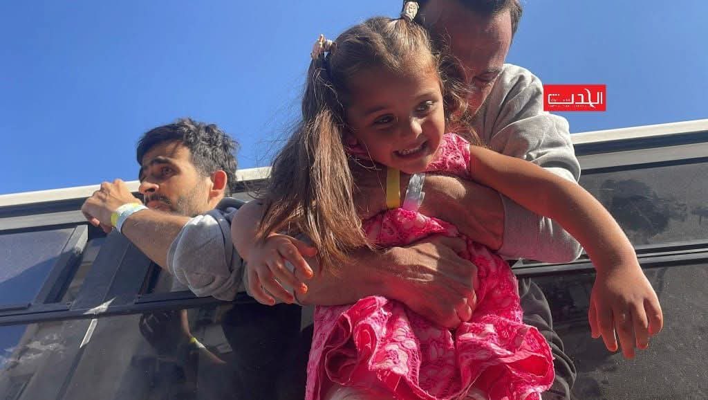 Palestinian hostage holding his daughter in Gaza.