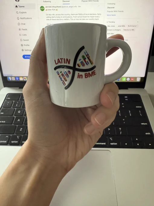A LatinXinBME-branded cafecito cup.