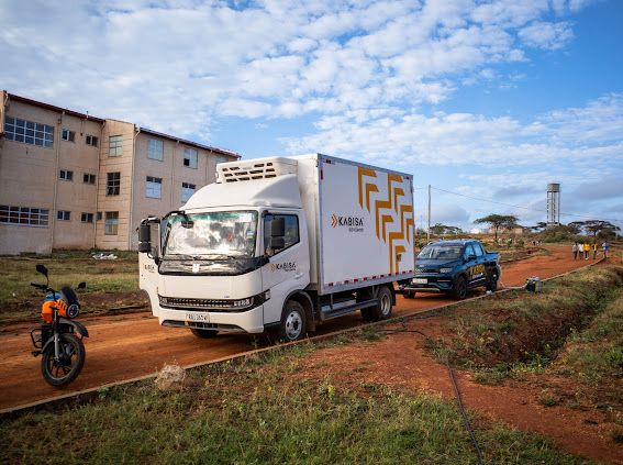 KenyaPower's tweet photo. The Kabisa Workhorses.
 
Part of the #RoadtoAddis convoy has been an e-pickup and an e-truck from @KabisaElectric,  two machines that have carried their weight and then some.
 
The e-pickup has led the charge from the front, mainly handling logistics. It’s the Geely Radar RD6; a refined drive with excellent power delivery and surprising comfort off-road. It has a 65 kWh battery, delivering roughly 320 km on a full charge.
 
The truck has brought up the rear, carrying, for example, extra batteries for the two e-motorcycles. It’s the GeelyH9E Light Truck, a 5-tonne refrigerated vehicle with a 132 kWh battery that delivers about 320 km on a full charge. Practical and steady over long distances, it’s well suited for transport and logistics, especially for moving perishables.
 
The truck is driven by Christian Byiringiro, who is a driver at Kabisa, and based in Rwanda. He says e-mobility has gained much traction in the country over the last few years. 
 
Christian drove the pickup from Kigali, Rwanda, leaving on Sunday, 28 September, and arriving in Nairobi on Wednesday, 1 October. This was his second drive from Kigali to Nairobi, the first being during Kabisa’s participation in Kenya Power’s 3rd E-Mobility Stakeholders Conference and Expo, held in May 2025 at the Kenyatta International Convention Centre.
 
He notes that drive was smooth thanks to the wider network of chargers in Rwanda and Uganda. He describes the Road to Addis as incredible and appreciates Kenya Power’s support in charging the e-convoy on the Kenyan side.
 
With him in the e-truck is Peter Kariuki, Charging Operations Assistant, Kabisa.
He calls the trip fantastic, insightful, and worth every kilometre. Through the Road to Addis, he’s seen how different utilities are working together to make e-mobility seamless with the necessary power access, grid stability, and the technical skill to back it all.
 
Kabisa, established in 2020, operates across East Africa and is developing an EV Highway linking Rwanda, Uganda, and Kenya to make cross-border electric transit easier. It has a wide range of products suitable for the Eastern African e-mobility market including trucks, pickups, SUVs, minibus, minivans, and prime movers. It offers complimentary services, both in-house and on the road, to all of its customers. 
 
For Kabisa, this journey is not just about reaching Addis. It’s about proving that an electric future for East Africa is already within reach.
#eMobility #PoweringEMobilityKE #TheFutureIsElectric #PoweringKenya #AEW2025 ^ZM