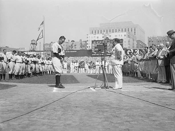 Mayor LaGuardia at microphone speaking as Lou Gehrig listens with bowed head at Yankee Stadium, July 4, 1939- Lou Gehrig Day.