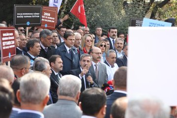 First image shows a group of men in suits and union vests standing at a podium with microphones, one holding a microphone and speaking, surrounded by Turkish flags and banners reading Türkiye Kamu-Sen and Increase Salary. Second image depicts a crowd of protesters holding signs like 2026 Budget Increase Salary and Justice in Salary, with a man in a suit speaking into a microphone amid trees and flags. Third image features participants holding a large red banner stating Justice Equality in Salary with the union logo, several men in formal wear standing together outdoors. Fourth image captures a large gathering with Turkish flags, banners protesting economic policies, and people in various attire assembled near buildings under sunlight.