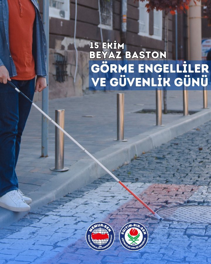 A man wearing an orange polo shirt, blue jeans, and white sneakers stands on a paved sidewalk holding a red-tipped white cane in his right hand, with metal railings and autumn trees in the background. The text 15 EKIM BEYAZ BASTON GÖRME ENGELLILER VE GÜVENLİK GÜNÜ is overlaid in white on a blue banner at the bottom. Logos of Eğitim-Bir-Sen and another organization appear in the bottom corners.
