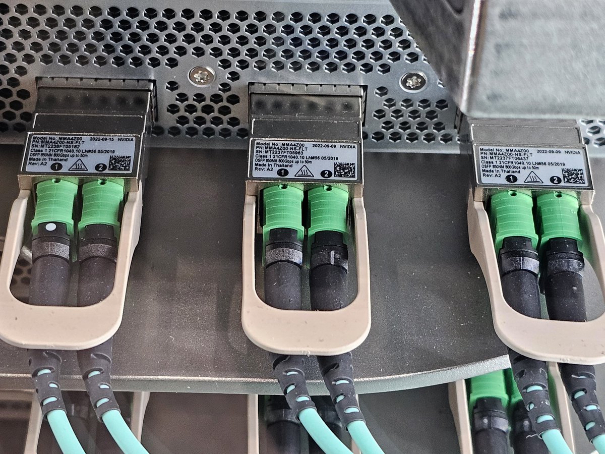 Uh... Why is the AMD Helios rack full of Nvidia tranceivers?
