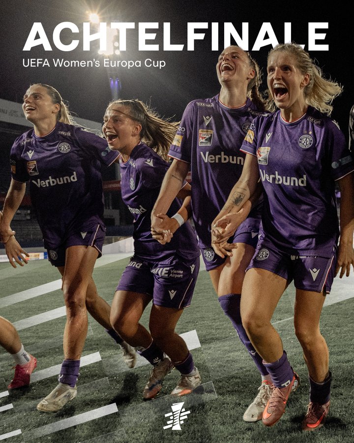 Four female soccer players in purple Verbund jerseys and shorts stand on a green soccer field under bright floodlights at night, joyfully embracing and laughing with arms around each other, one with blonde hair flying, another with a ponytail, all wearing cleats and socks, UEFA Womens Europa Cup logo visible, text ACHTELFELFINALE overlaid in white.