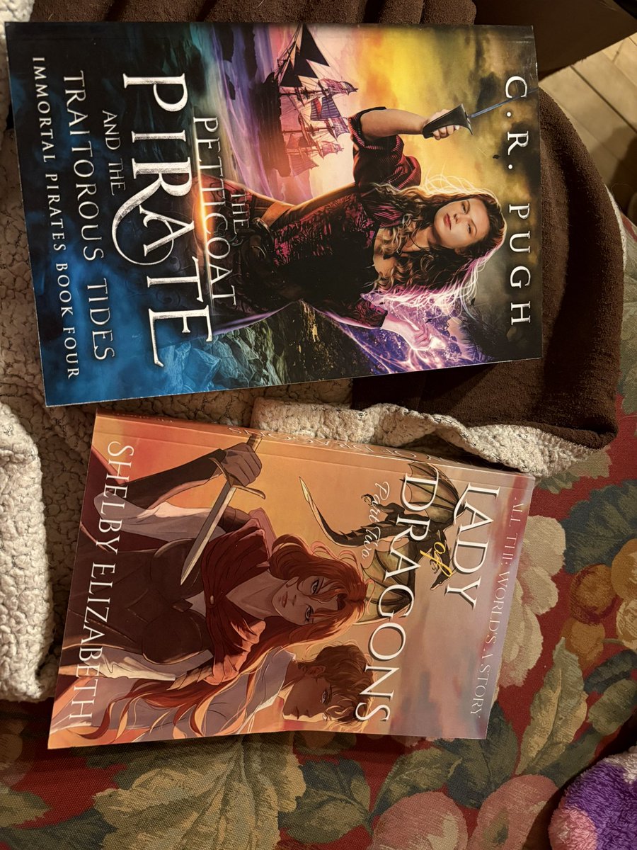 Book Mail!

Got the final book of The Immortal Pirates by <a href="/AuthorCRPugh/">👻🎃 C.R. Pugh 🎃👻</a> ! She be THICK 😄 (the book😅)

And Lady of Dragons book 2 by <a href="/ShelbyEBooks/">Shelby Elizabeth ~ YA fantasy/romance author</a> 

They get to be added to my book wall!😁