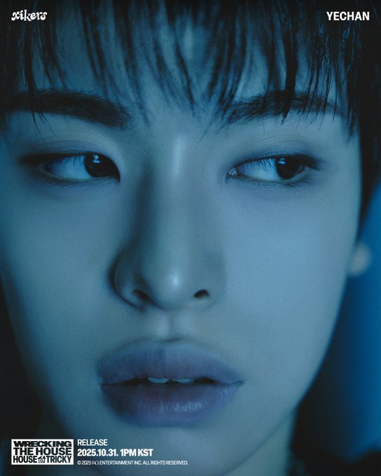 First image shows Yechan from xikers posing dynamically in a dark feathered jacket over a white top with blue graffiti background and text XIKERS YECHAN RELEASE 2025.10.31 1PM KST HOUSE OF TRICKY WRECKING THE HOUSE. Second image depicts Yechan close-up with serious expression long dark hair blue lighting and same album text overlay.
