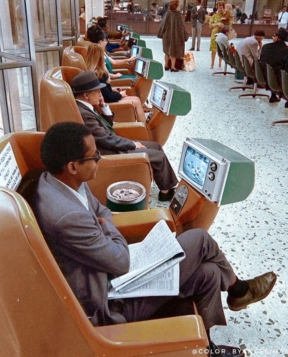 Passengers watching coin operated TVs at the L.A. Greyhound Terminal (1969)