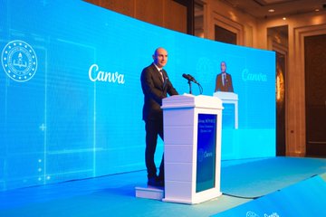 First image shows a large group of formally dressed men and women standing side by side on a stage with blue backdrop displaying Canva İş Birliği Protokolü Tanıtım Toplantısı text and Turkish flag emblem. Second image depicts a man in suit speaking at a white podium with microphone, large Canva logos on blue screens behind, another suited figure visible on a screen. Third image features a bald man in suit at a podium with microphone, Canva branding on screens, ornate room setting with blue lighting. Fourth image captures a panel of six people in business attire seated at a table on stage with blue Canva backdrop announcing 16 Ekim 2025 Ankara event, including men and women some wearing headscarves.