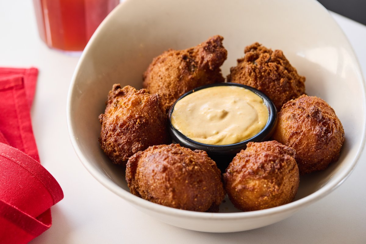 Try our Jalapeño Loud Puppies, crafted with Homestead Village's unrefined cornmeal from Brazos de Dios! These delightful bites are served with our house-made rémoulade for a perfect pairing.