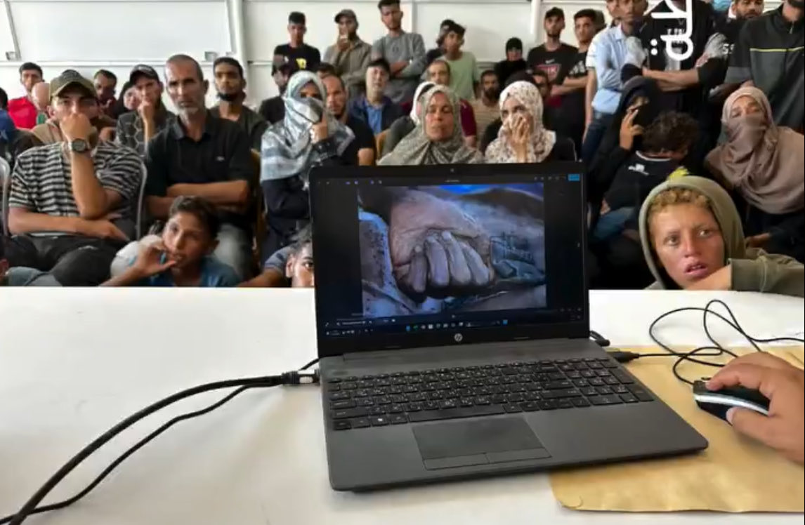 swilkinsonbc's tweet image. At Nasser Hospital southern Gaza, families gather before a large screen showing photos of tortured Palestinian bodies released by the israelis