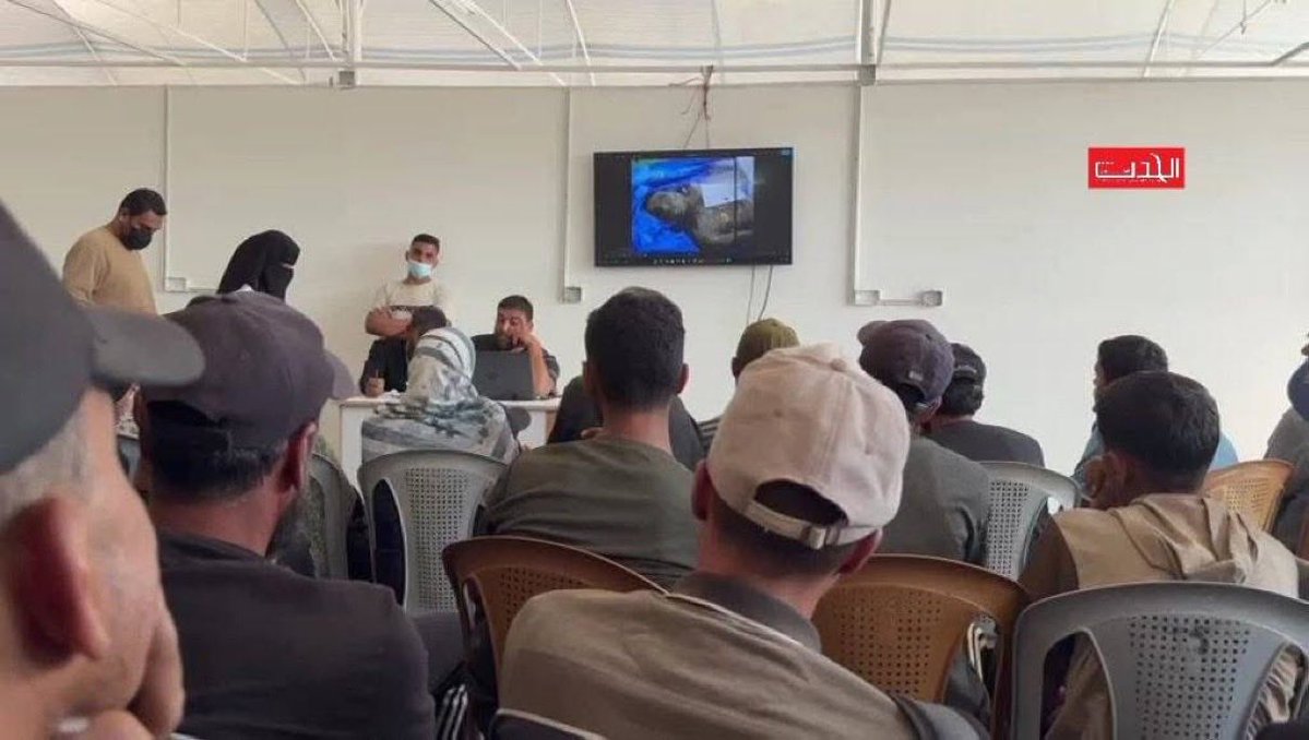 swilkinsonbc's tweet image. At Nasser Hospital southern Gaza, families gather before a large screen showing photos of tortured Palestinian bodies released by the israelis