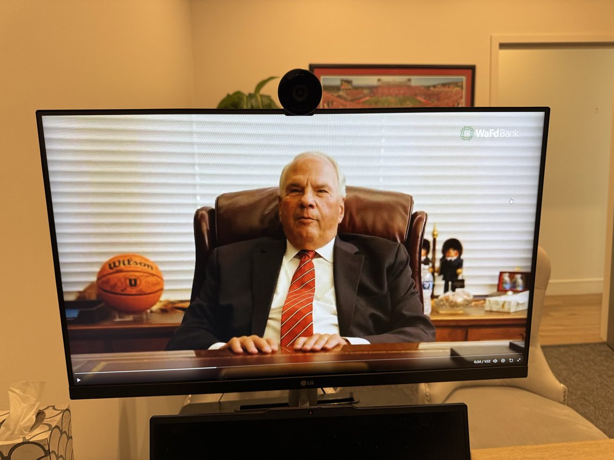 Elder Rasband on rivalry week gushing about his Utes with a Ute bball in his office .