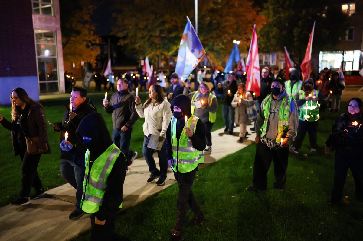 Members of the community, police, elected officials, and interfaith leaders attend a candlelight walk around Cicero Town Hall after several increased immigration enforcement actions took place in the area Thursday evening in Cicero.