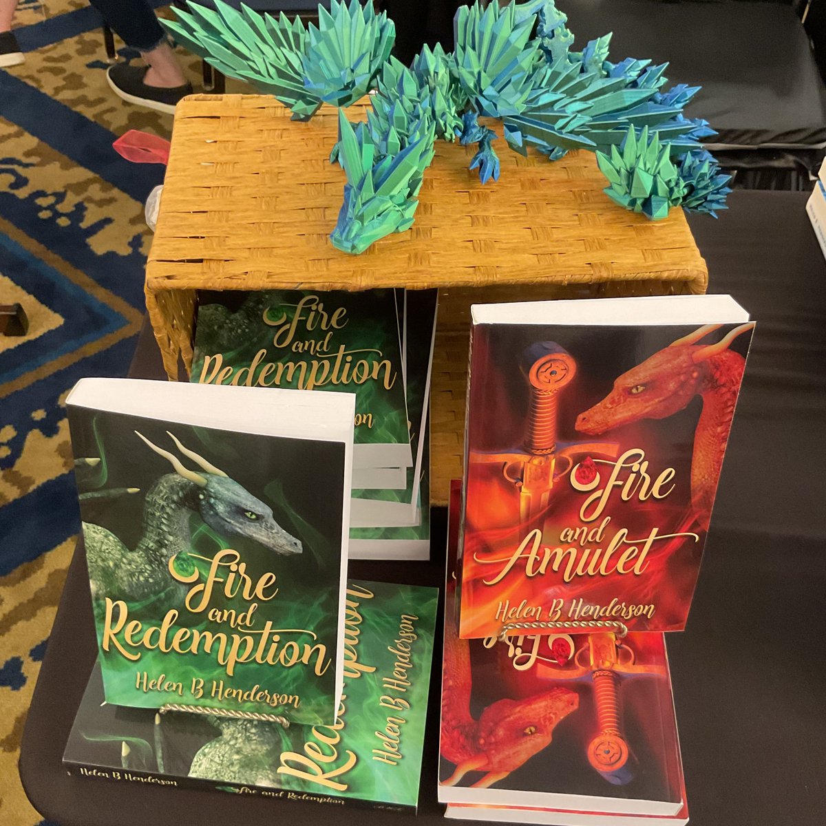 history2write's tweet photo. Had a great time at Books By The Arch. People pulled grocery carts and wheeled backpacks full of books and played author bingo. A popular newcomer to my table presentation was Medraut, who lounged on a wooden box overlooking the book series he was a character in. #dragonshifters https://t.co/NMPCamtGcO
