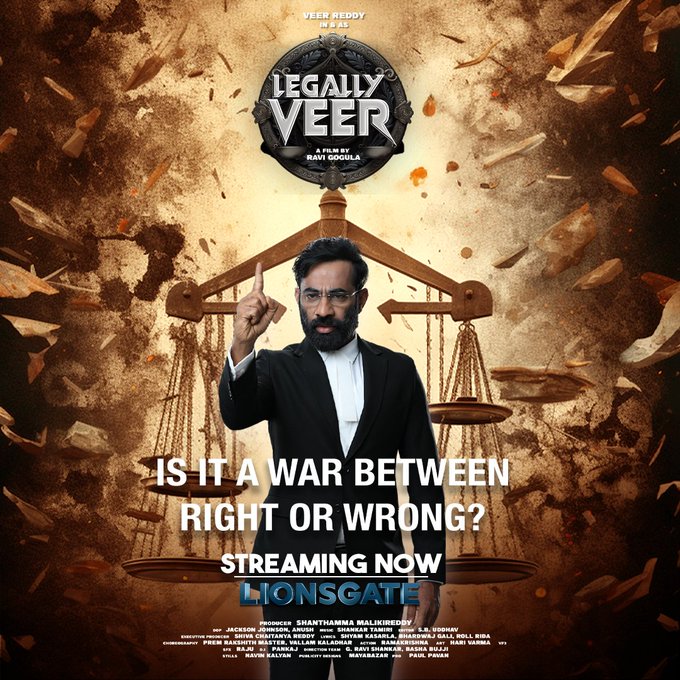Dramatic movie poster for Legally Veer shows actor Veer as a lawyer in black suit and white shirt pointing assertively with right hand raised. He stands between two gavels on wooden stands with explosive orange effects and debris around. Background includes faint gavel symbols and text overlays like Legally Veer title in bold red and white fonts Veer title in yellow. Bottom credits list cast including Veer and Rashmika Mandanna director and production details. Promotional text reads Is it a war between right or wrong Streaming now Lionsgate.